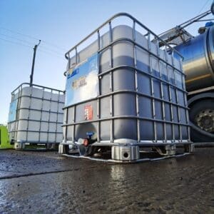 Large metal silos outside next to large truck