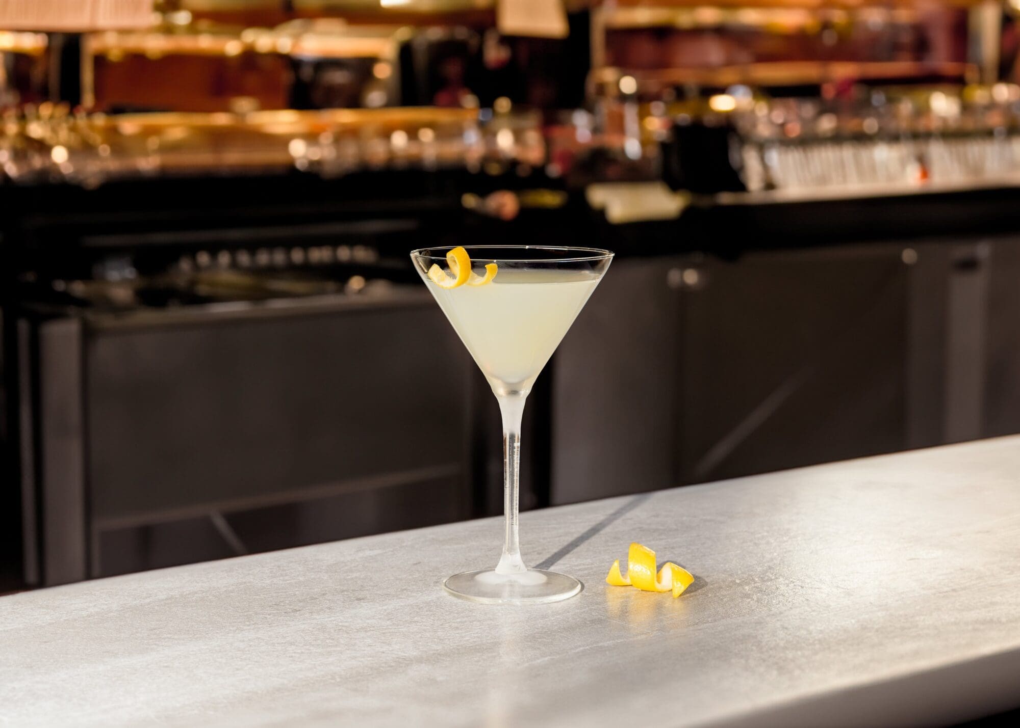white lady cocktail min on a bar with blurred background